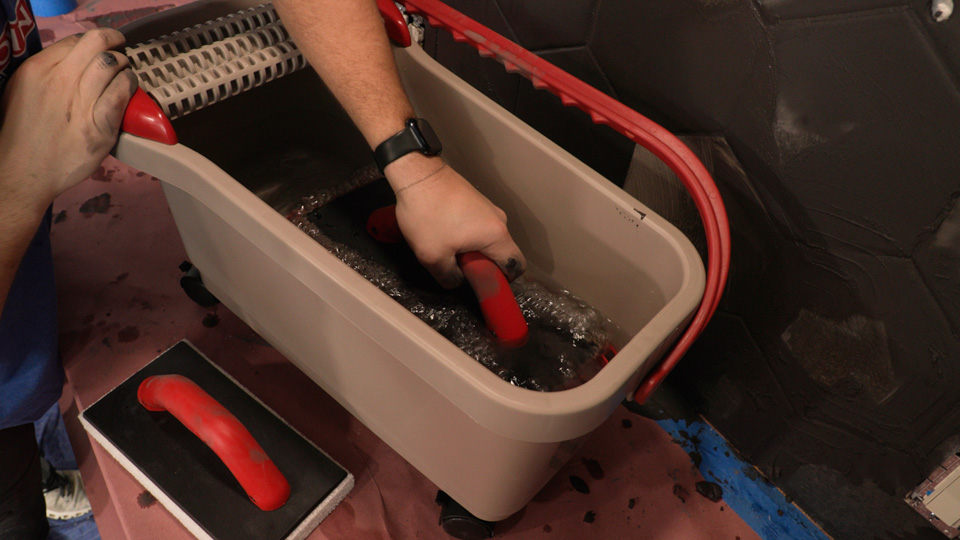 Ultra Grouting System step 2 cleaning the grout from the sponge